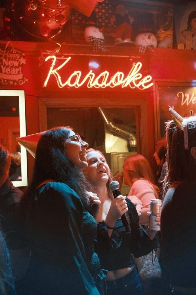 pexels-photo-29298514-29298514 A group of friends enjoying karaoke at a lively New Year's Eve party.