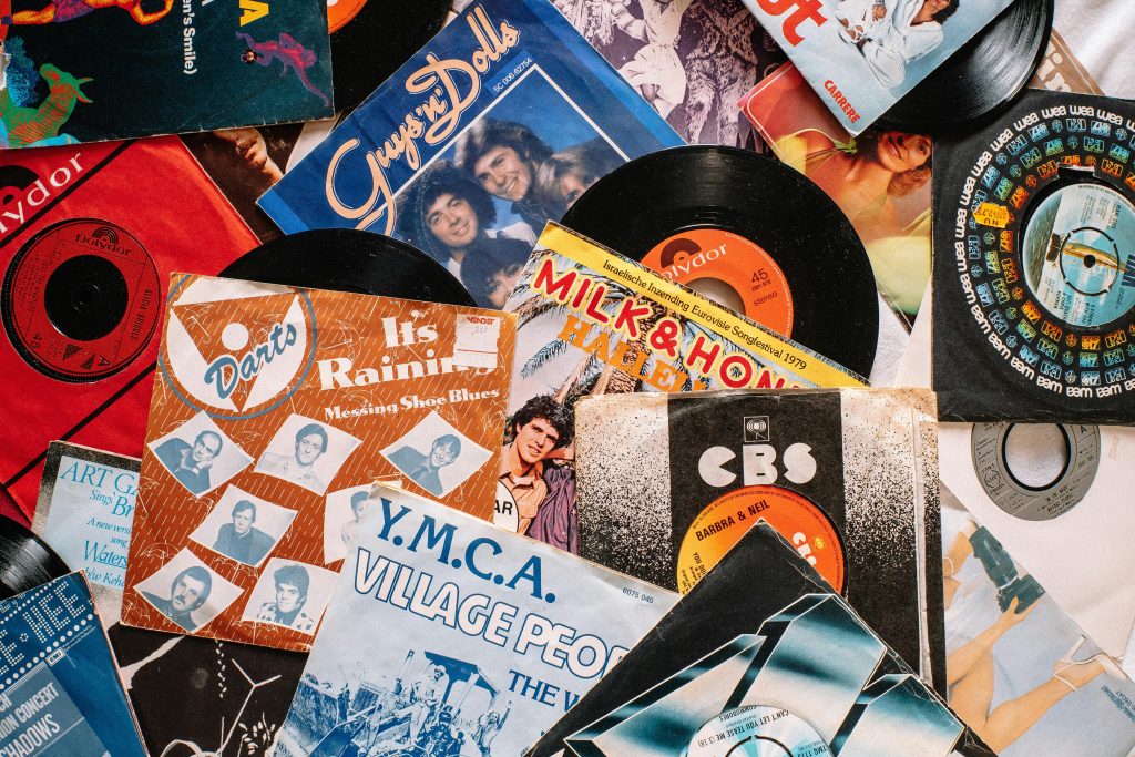 pexels-photo-4200745-4200745 A flat lay of vintage vinyl record covers showcasing 70s and 80s music nostalgia.